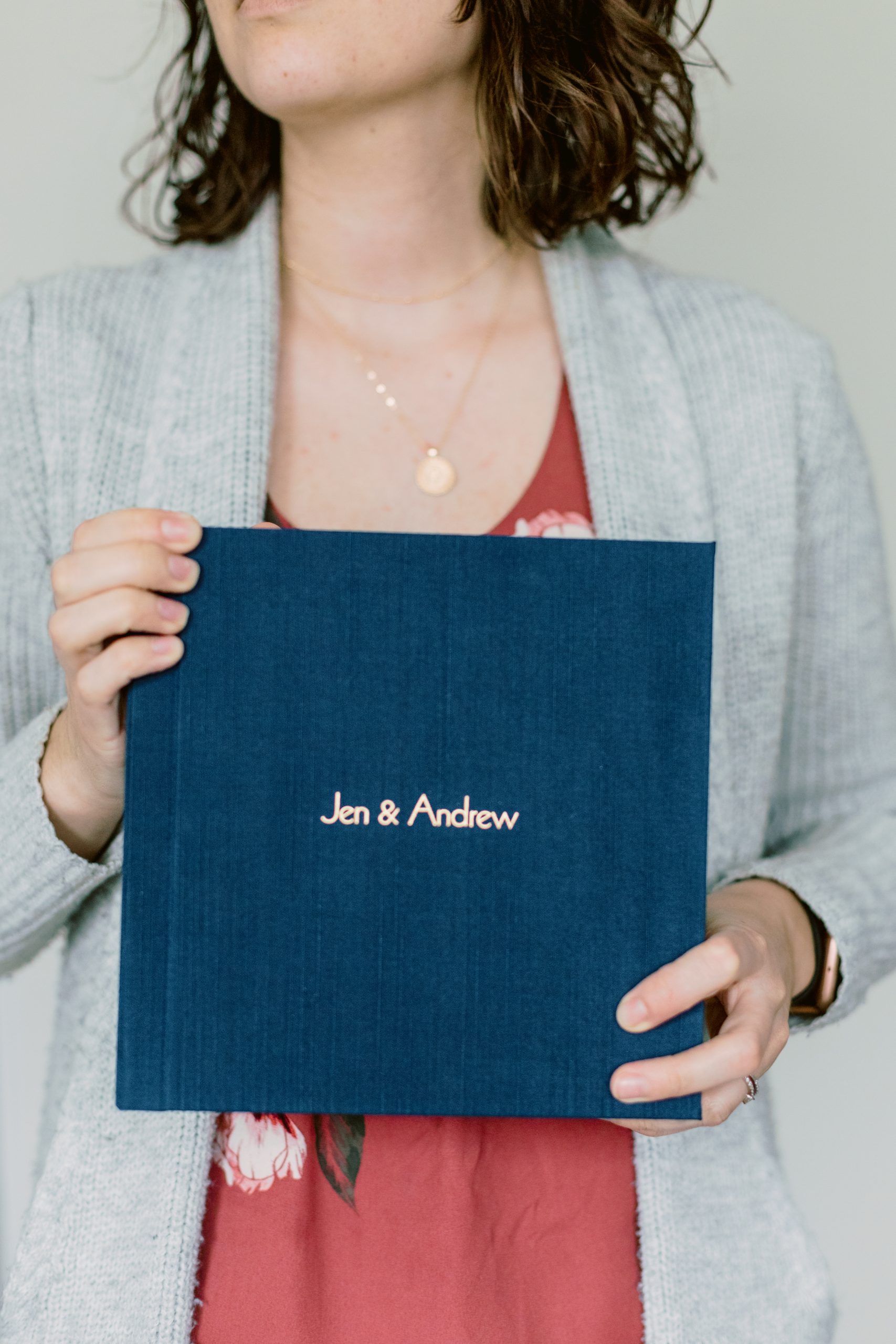 Woman holding a blue wedding album