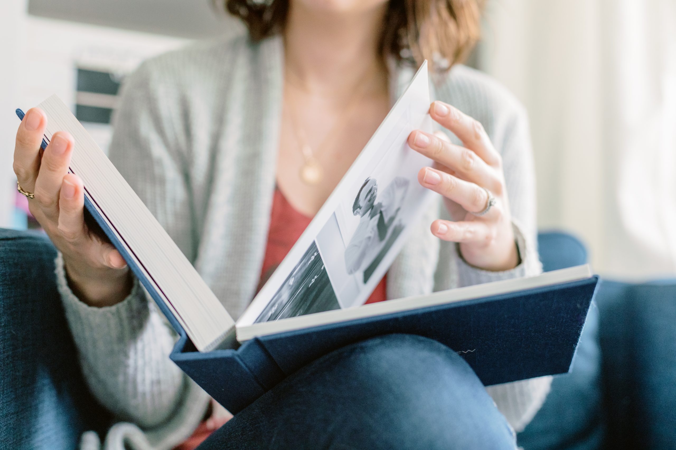 Woman sitting and looking through album