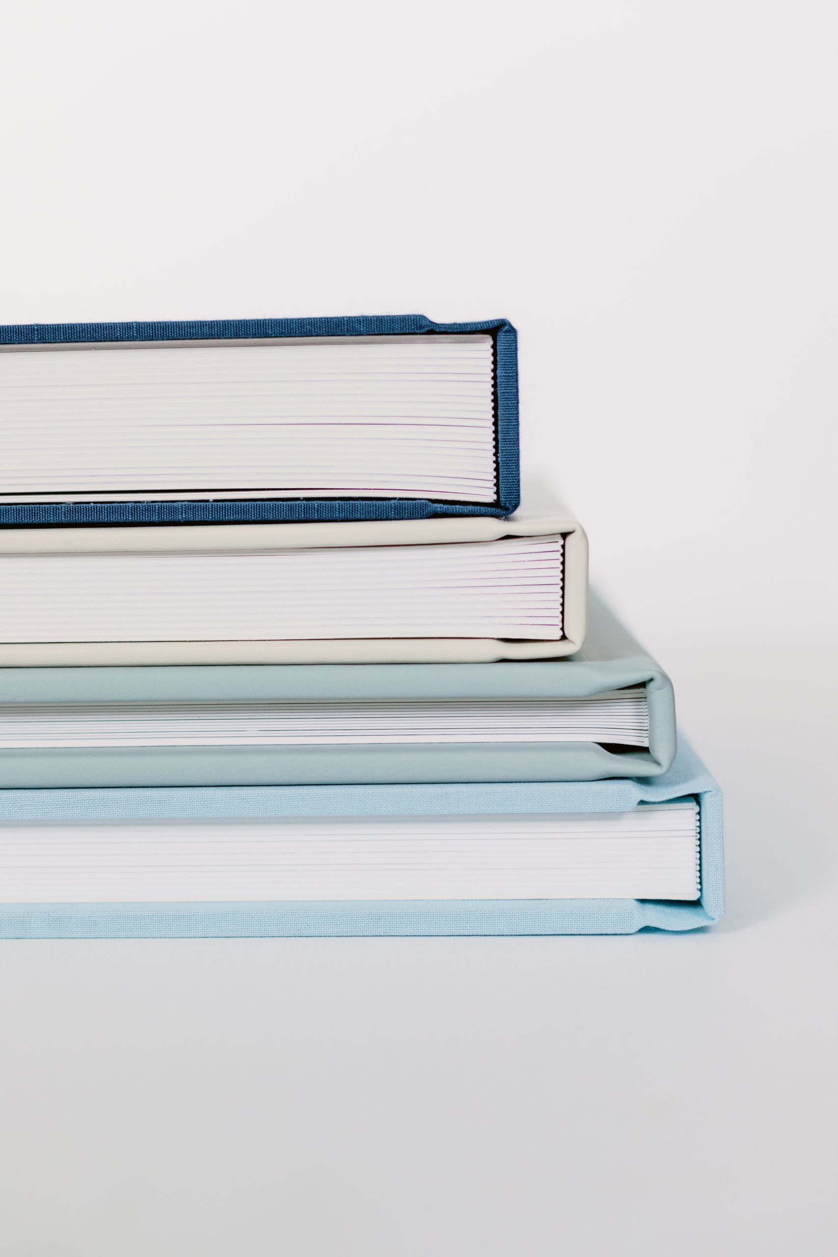 Four wedding albums in a pile